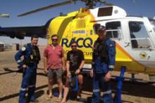 Image of the rescued motorcyclists with the crew of the rescue helicopter