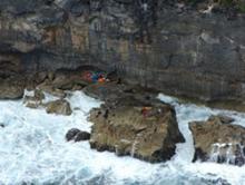 Image of debris and lifejackets mark the location on rocks at Christmas Island