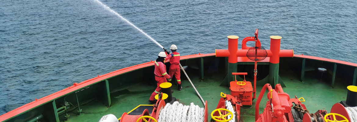 Image of firefighters using a fire hose on a vessel"