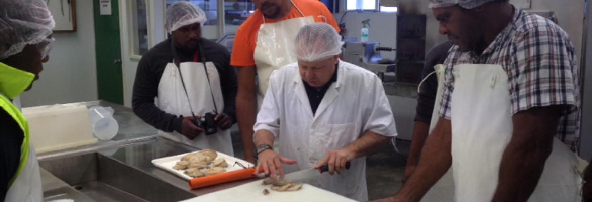 Students receiving instruction in handling and packaging seafood products