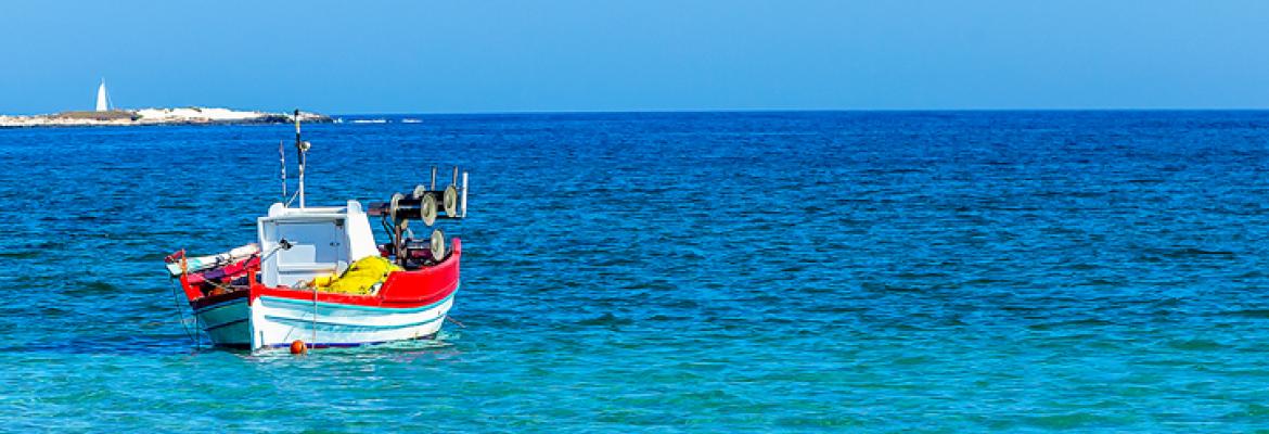 wooden boat in a clear blue sea
