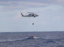 helicopter winching passengers from the Jedi boat