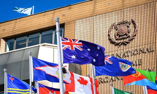 Australian flag with flags of other nations in front of IMO building