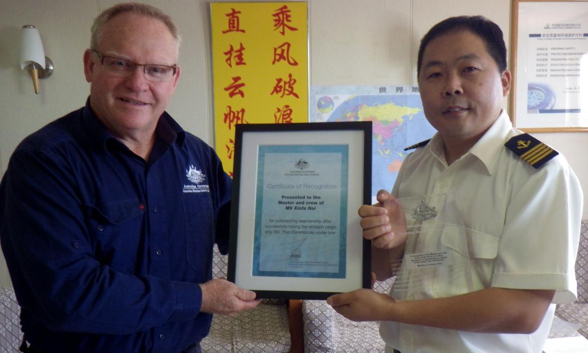 AMSA Surveyor Greg Collinson presents Captain Li with the certificate and plaque