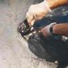 An official getting samples of oil from an oil slick