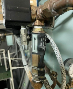 A photo showing a flow sensor and alarm fitted to the 15ppm bilge alarm sample line