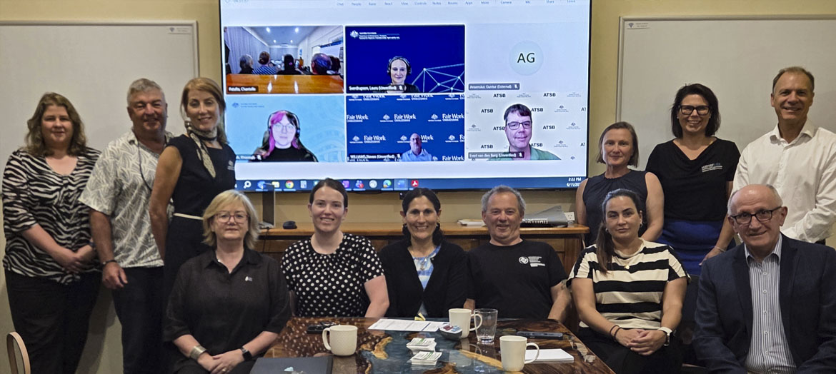 ASWC members in a group in person with additional members on screen
