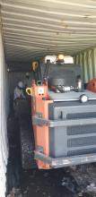 Bobcat cleaning out container