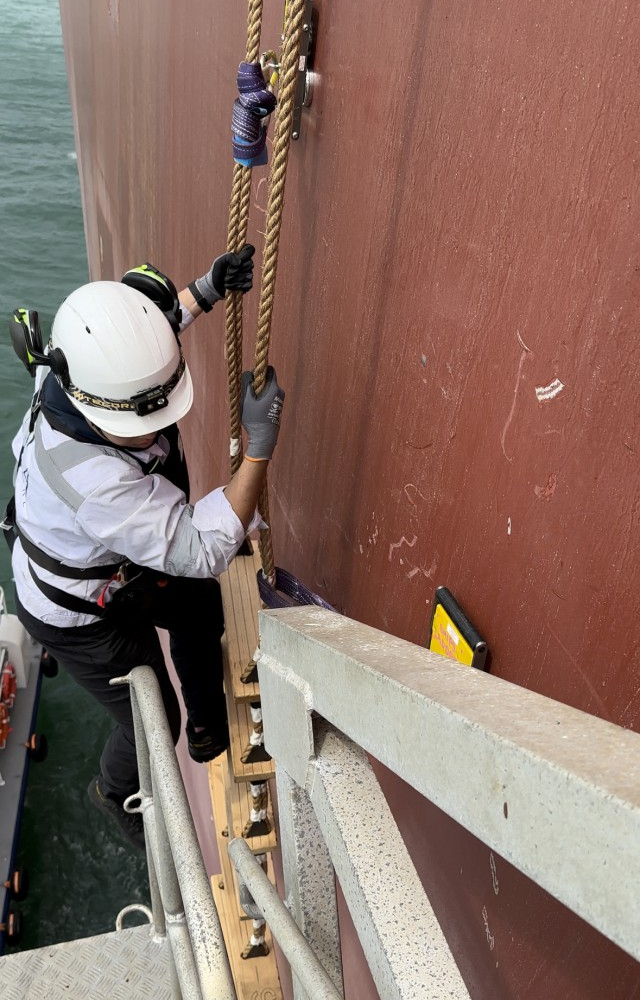 Person unable to safely access accommodation ladder platform from pilot ladder.