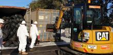 Opening a container full of tyres