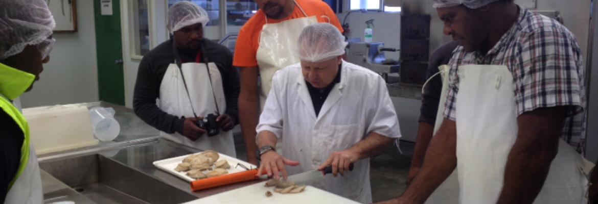 Students receiving instruction in handling and packaging seafood products Students receiving instruction in handling and packaging seafood products
