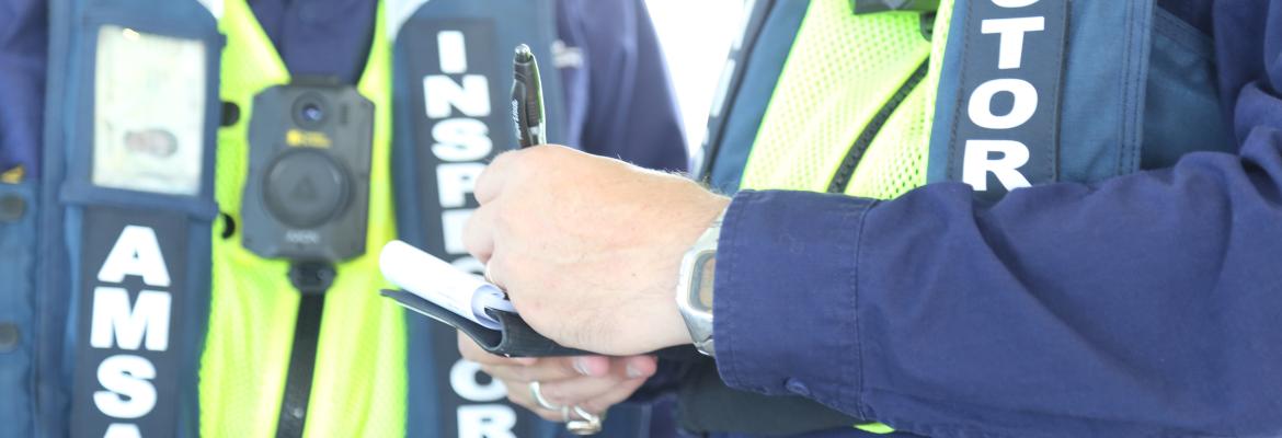 Close up of two AMSA inspectors. One of these inspectors is taking notes
