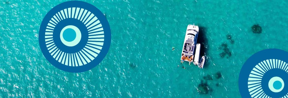 aerial view of small boat in turquoise waters of Torres Strait