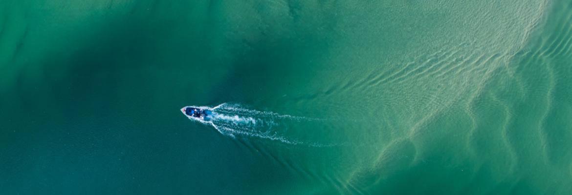 aerial view of small boat in green seas