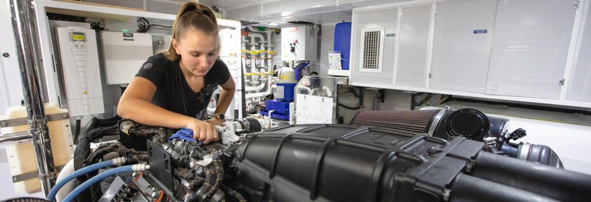 woman looking at an engine