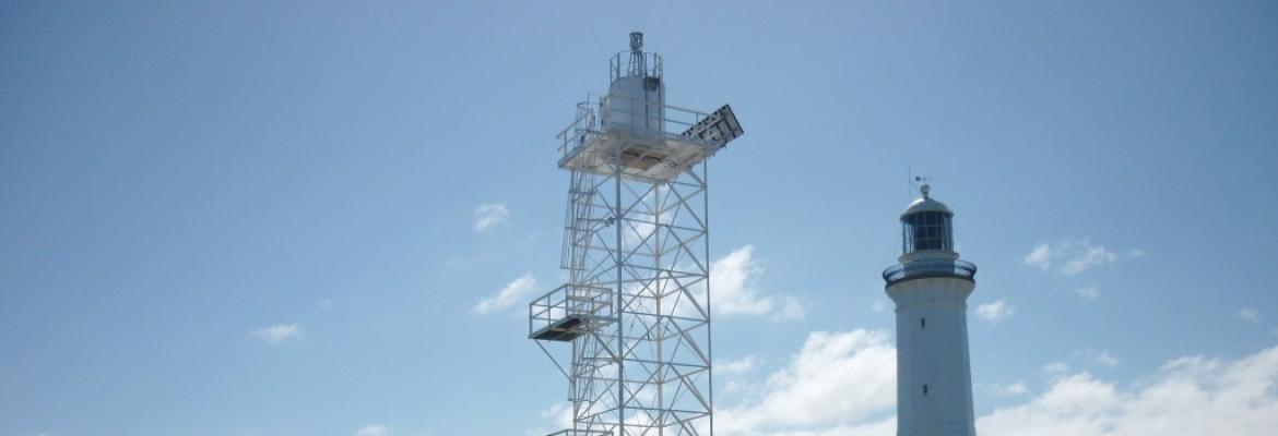 lighthouse and aid to navigation pictured against the sky