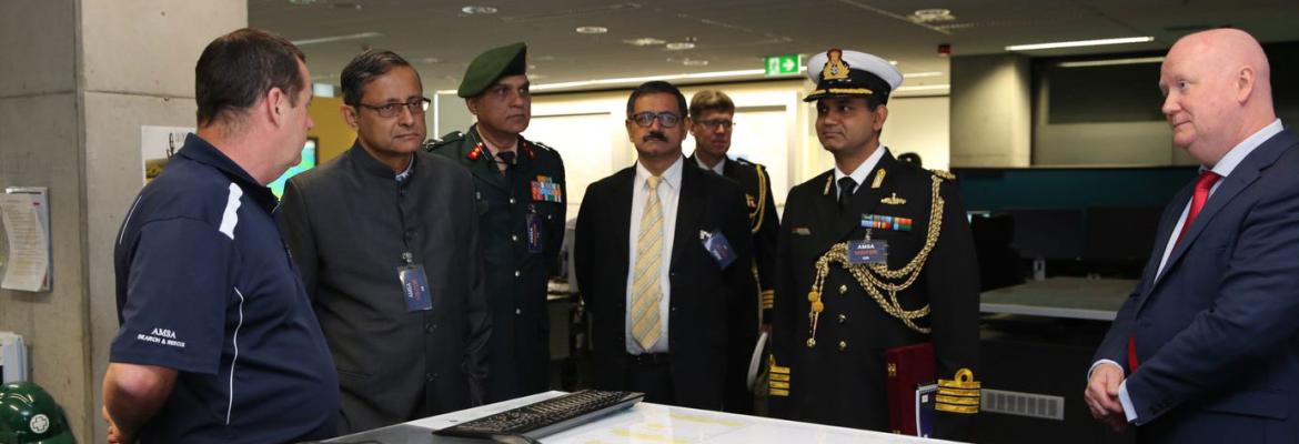 Our Chief Operating Officer, the Indian Secretary of defence and other members standing around a navigation table