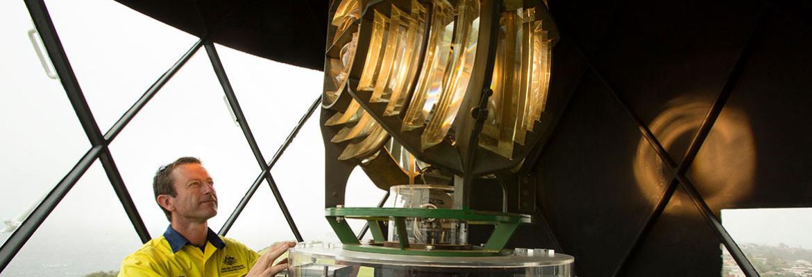 AMSA officer looking up at Macquarie light inside the lighthouse