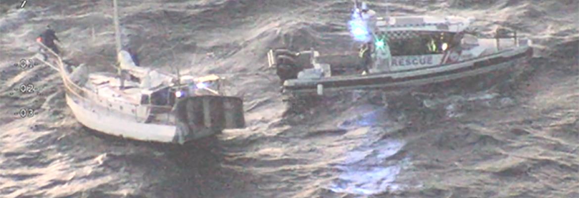 Police rescue boat and yacht being rescued