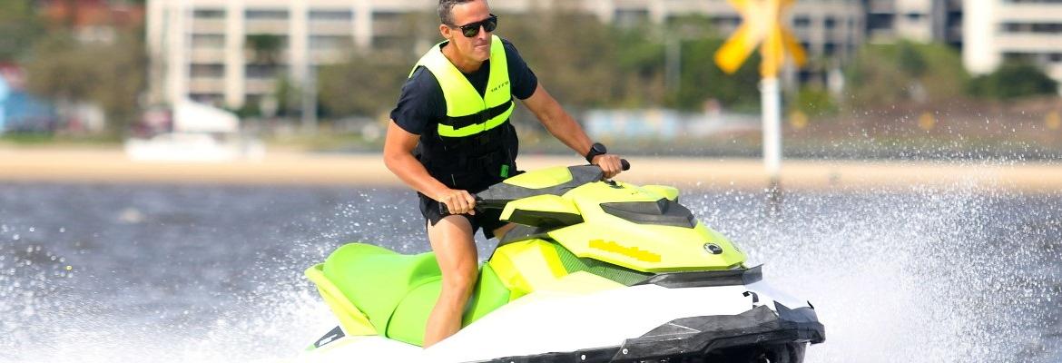 Man in lifejacket driving jet ski