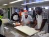 Students receiving instruction in handling and packaging seafood products