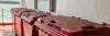Large red recycling hoppers on board a vessel