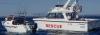 A rescue vessel assisting a smaller fishing boat