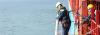 Seafarers preparing a pilot ladder on a large vessel