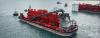 MinRes Airlie, a 123.8-metre transhipper and one of the two largest new domestic commercial vessels built in 2023–24, shown operating at sea. The red vessel features large onboard bulk handling infrastructure and is part of a matched pair with MinRes Coolibah.