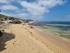 Rocky beach under blue and cloudy sky, Woodman Point, Western Australia