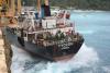 Image of MV Tycoon being washed against cliffs