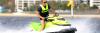 Man in lifejacket driving jet ski